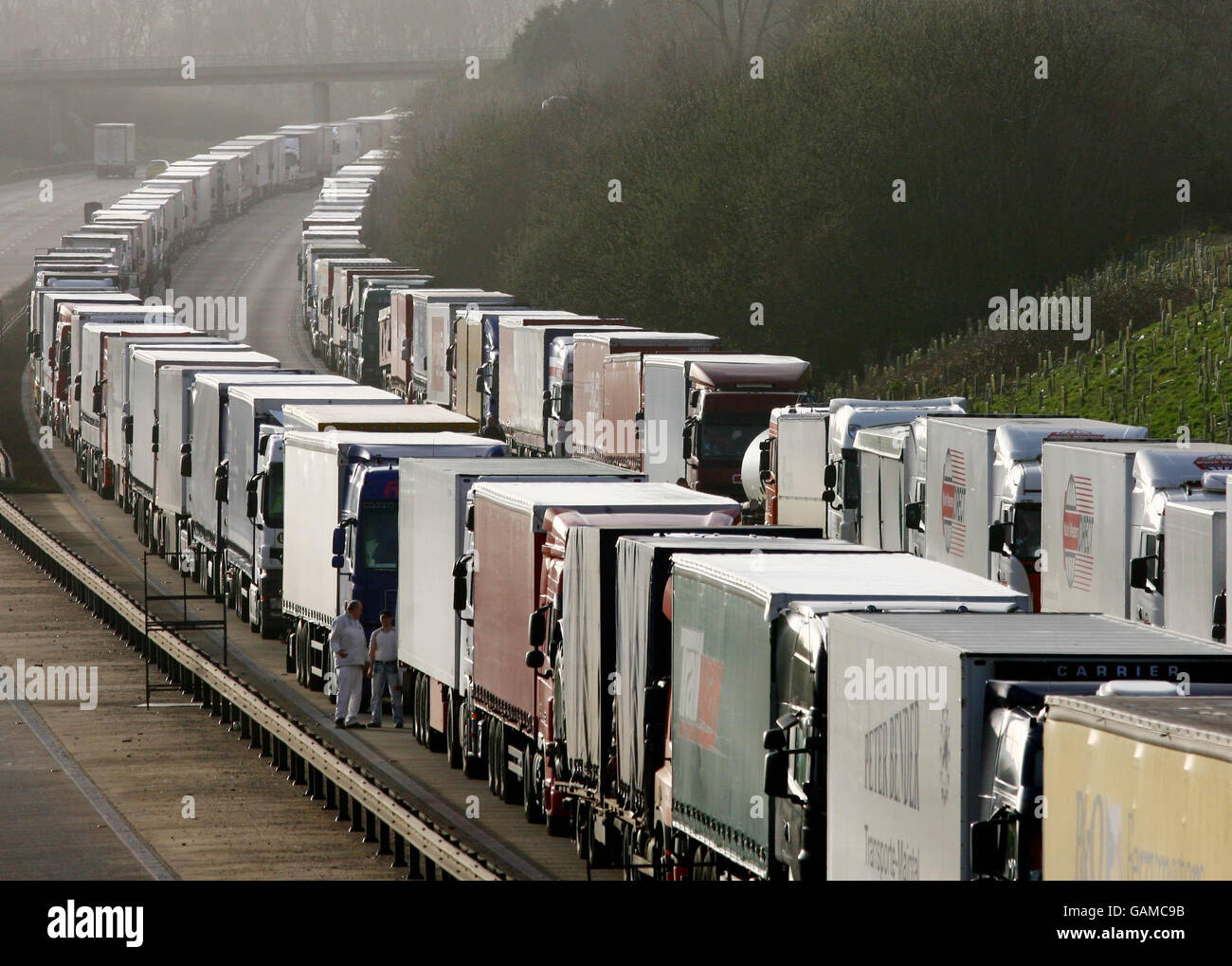 Lorry drivers wait to cross The Channel as Operation Stack is re-instated on the M20 near Ashford in Kent due to industrial action in France. Stock Photo