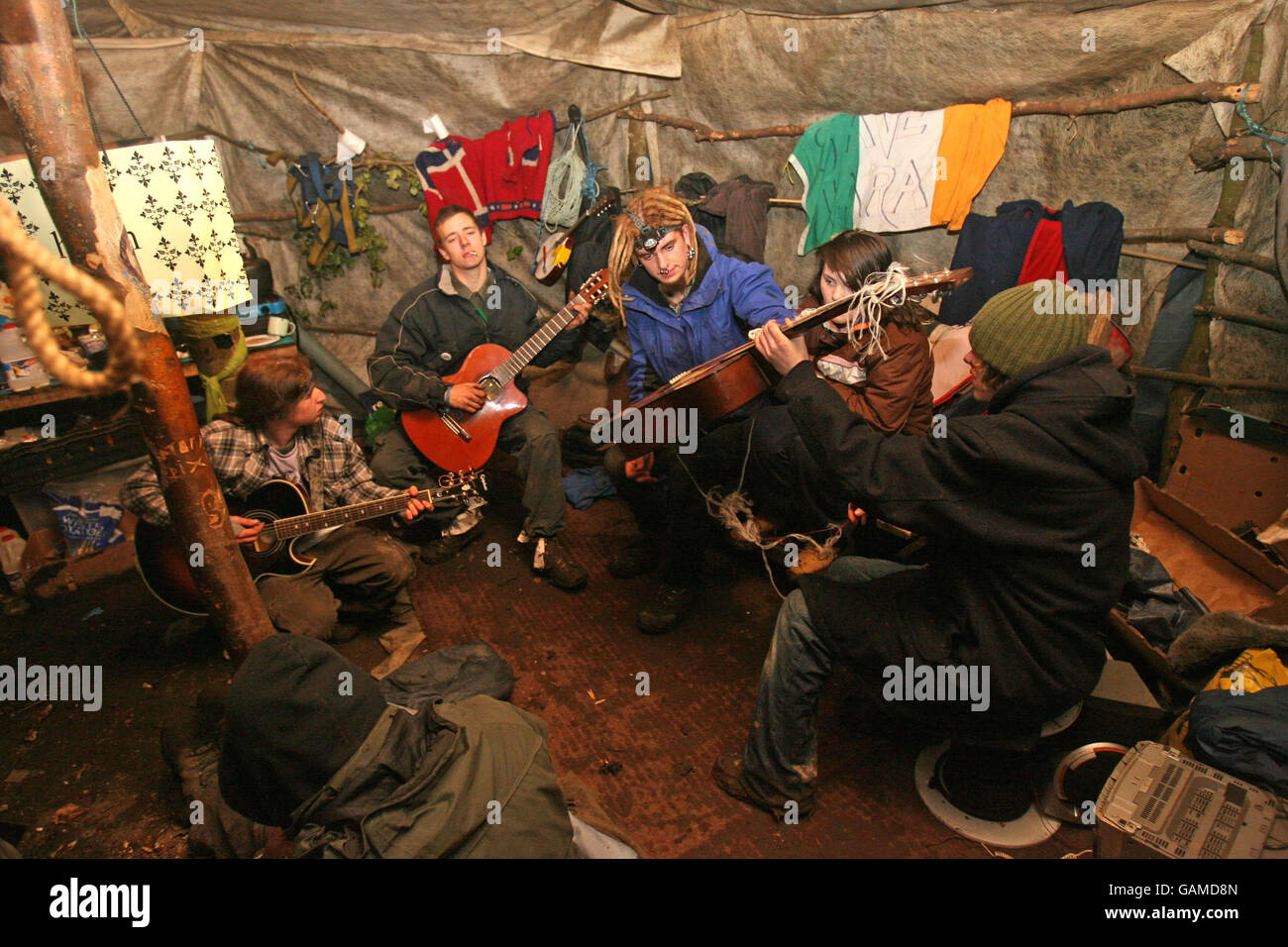 Members of the Rath Lugh Direct Action group play music in a tent they have named 'the round house' at the M3 Motorway site at Rath Lugh in Co Meath. Psychology graduate Lisa Feeney, known as Squeak, barricaded herself inside a chamber built at the bottom of a 33ft tunnel in a bid to delay work today on a controversial section of a motorway . Stock Photo