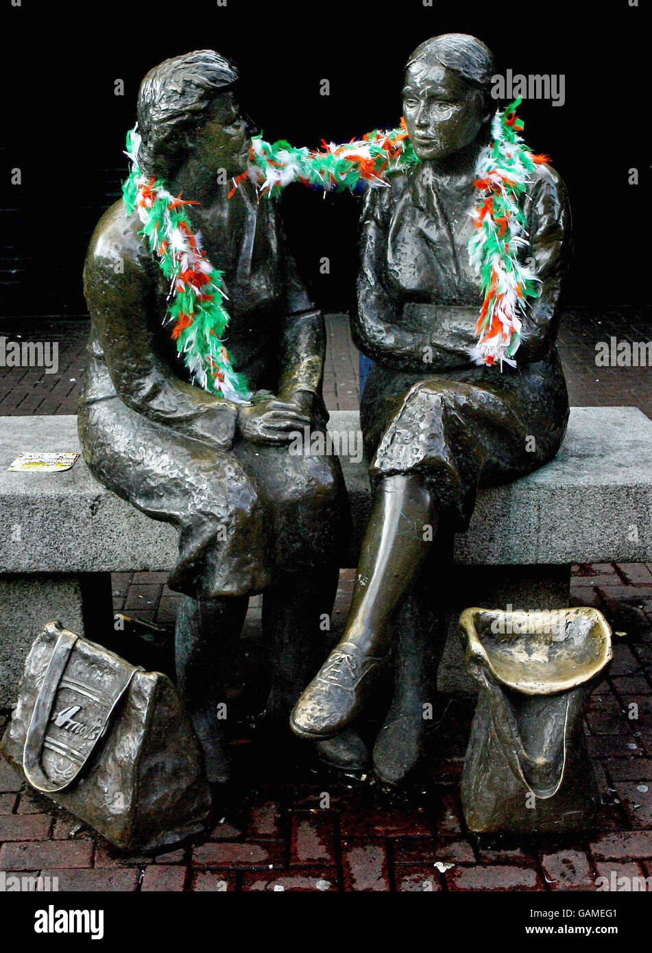 A feather boa is left on Dublin's famous "Hags with the bags" statue in