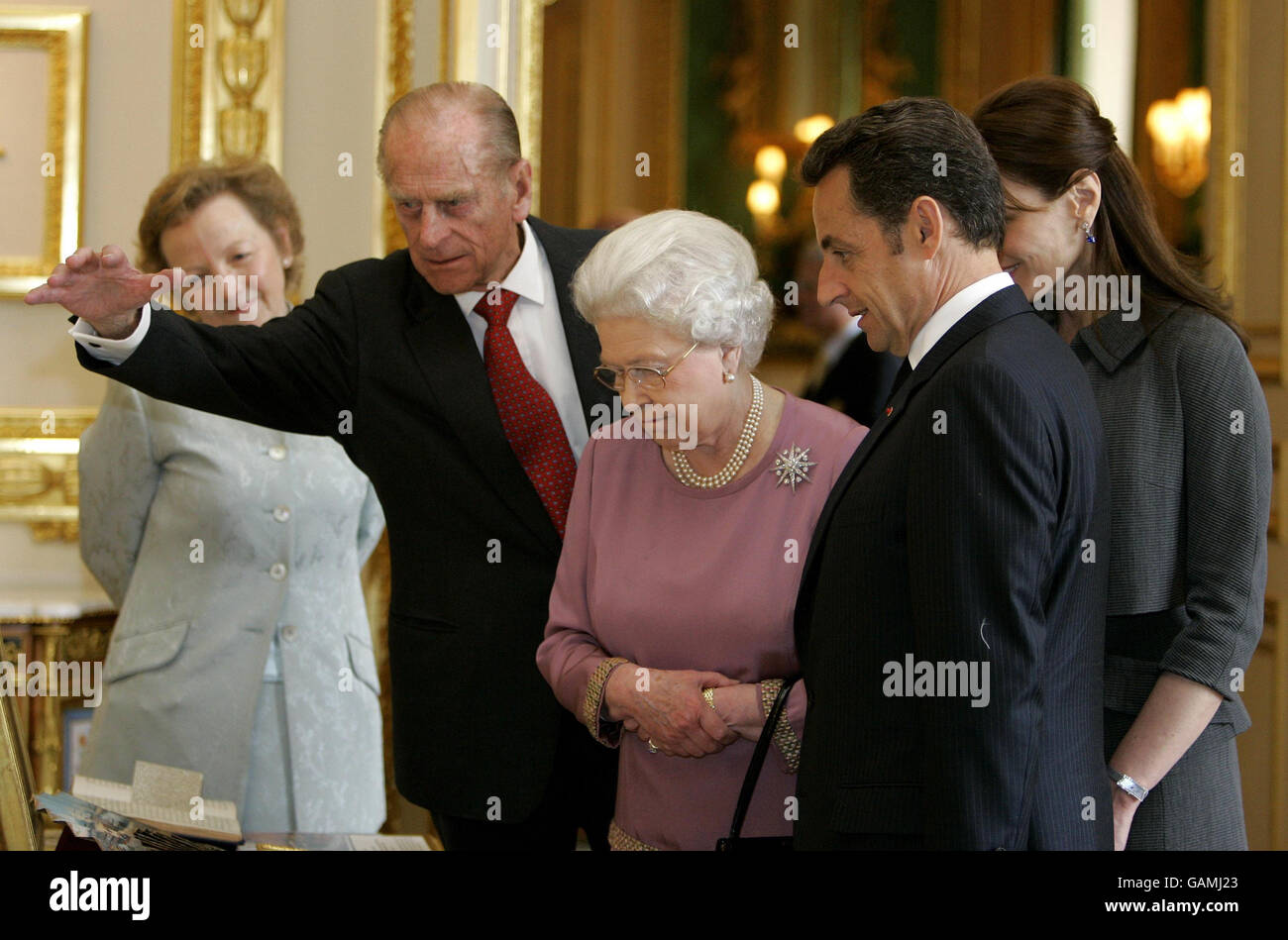 French President Nicolas Sarkozy, right, and his wife Carla Bruni-Sarkozy are shown items from the Royal Collection by Britain's Queen Elizabeth II and the Duke of Edinburgh at Windsor Castle. Stock Photo