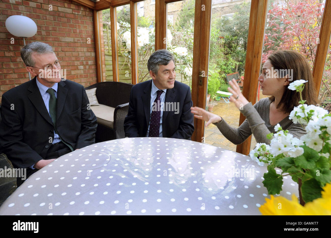 Maud Mansfield (right) talks to Environment Secretary Hilary Benn (left) and Prime Minister Gordon Brown about energy saving in her home in Hammersmith, west London this morning. Stock Photo