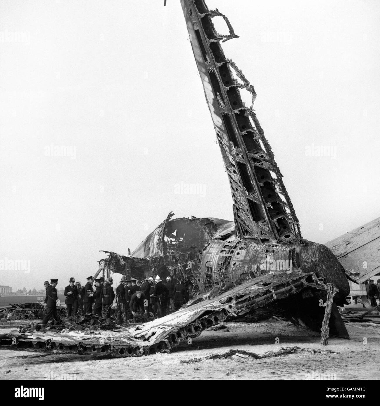 The skeleton of the tail rears from the blackened wreck of the Australia bound Boeing 707 jetliner of BOAC Flight 712 which crashed in flames at Heathrow Airport, only 4 minutes after take-off. Of the 127 people on board, 122 were known to have survived. There were 5 dead, including Barbara Jane Harrison, a flight attendant, who was awarded the George Cross for heroism. Stock Photo