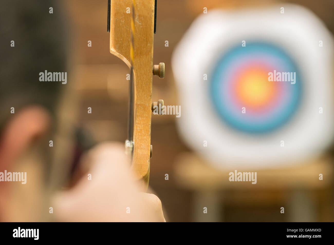 Archer aiming against the blurred target. Stock Photo