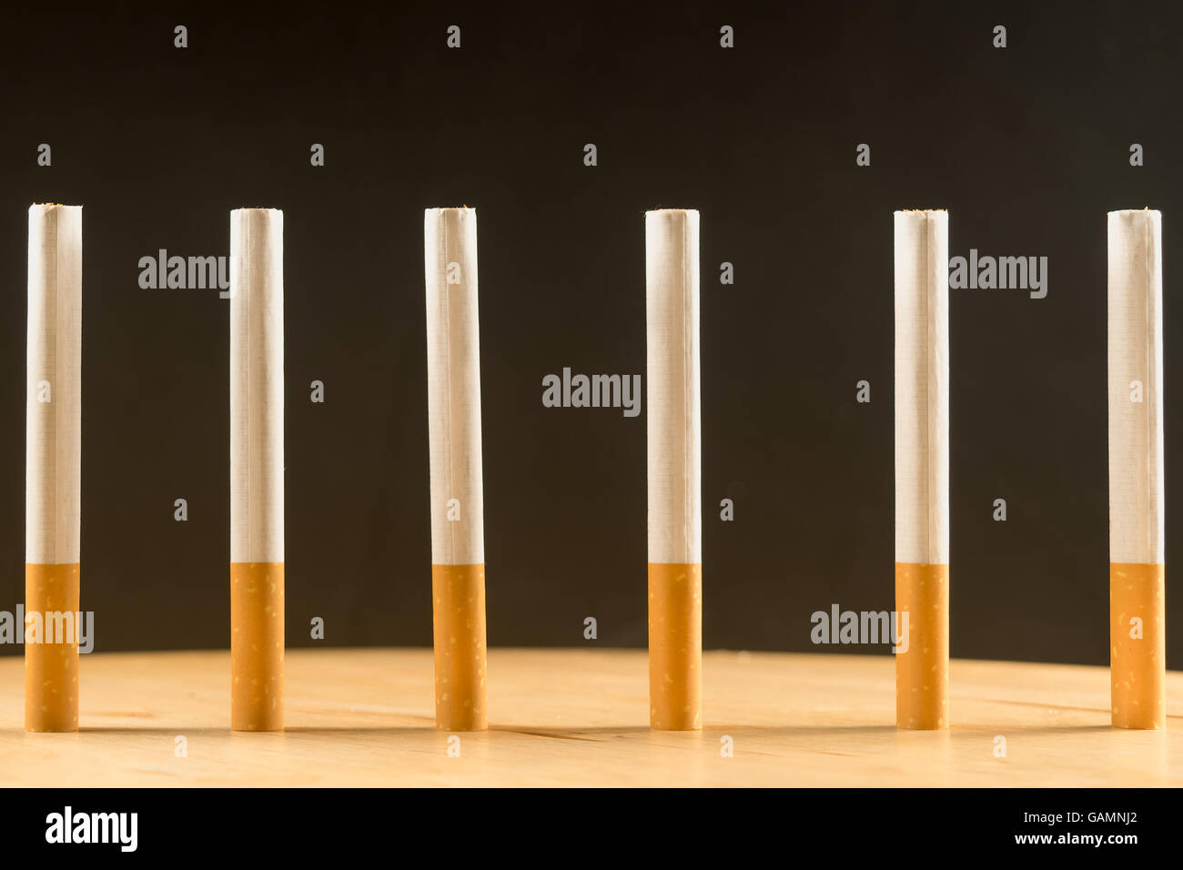 Six cigarettes standing in a row as a concept of prison bars Stock