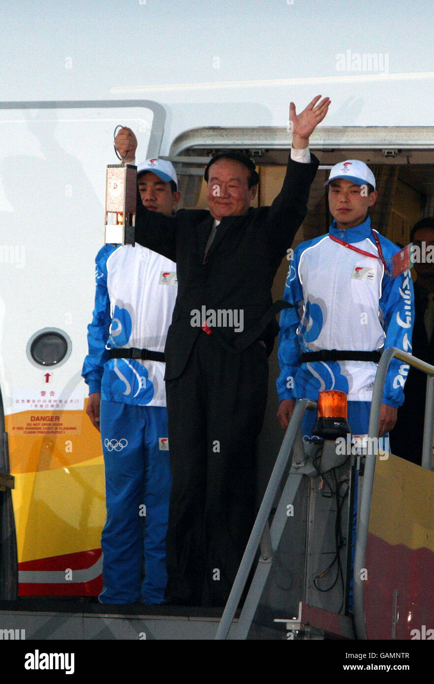 Deputy Executive Chairman of the Beijing Olympic Committee Jiang Xiaoyu carries The Olympic Flame as it arrives at the Royal Suite at Heathrow Airport under heavy Security. Stock Photo