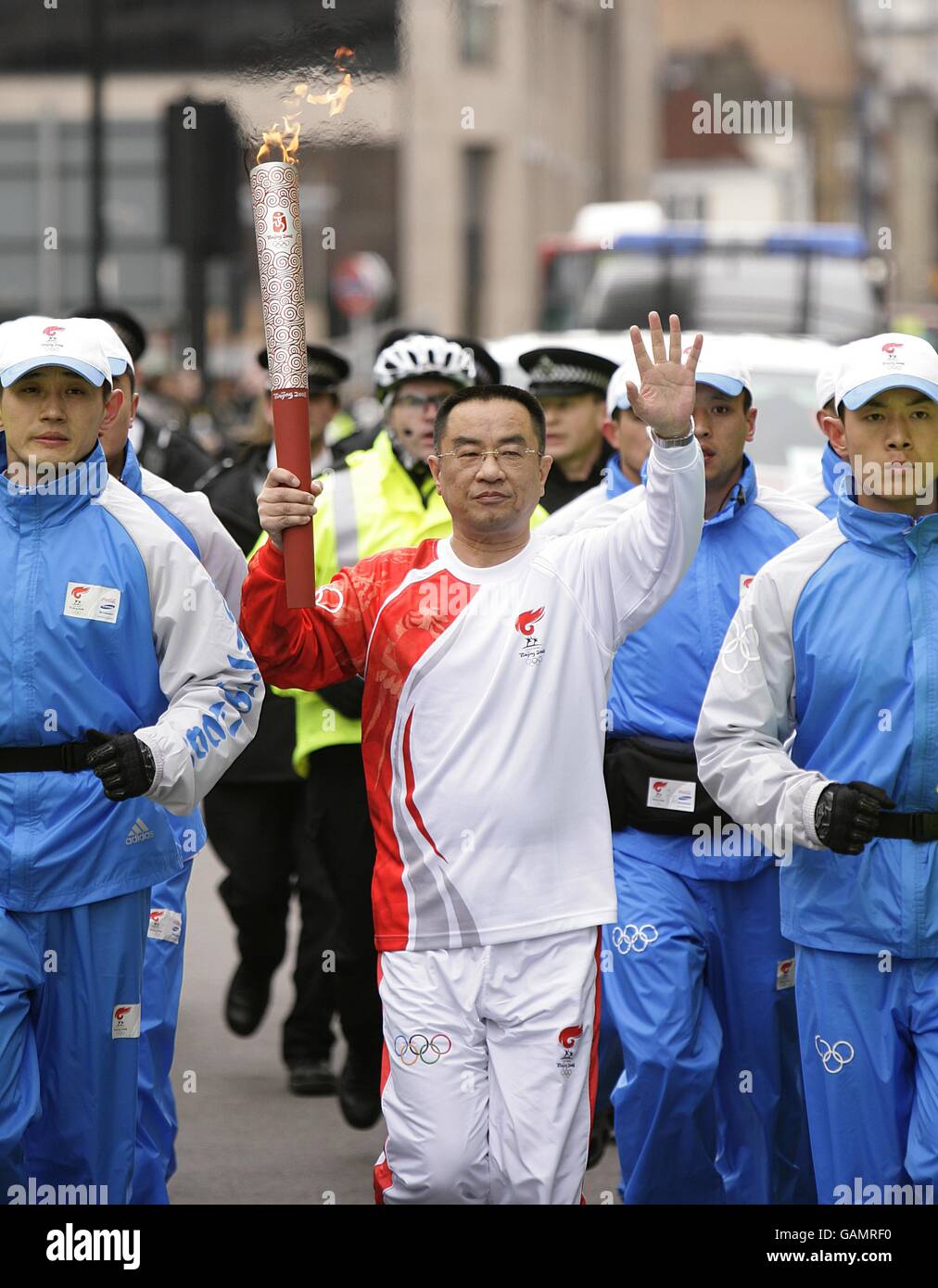 Beijing Olympics Torch Relay London. The torch is carried towards Whitechapel Road during the