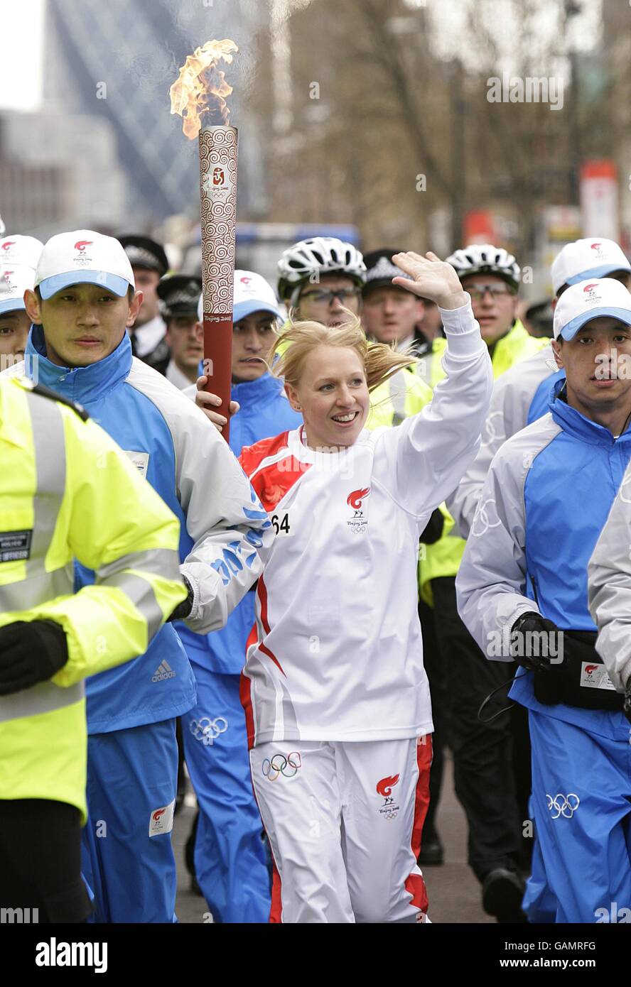 Beijing Olympics Torch Relay London. The torch is carried towards Whitechapel Road during the
