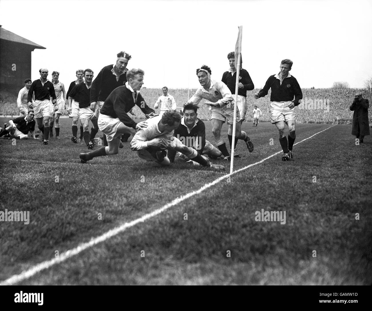 England's Peter Thompson (c) dives over to score his team's second try ...