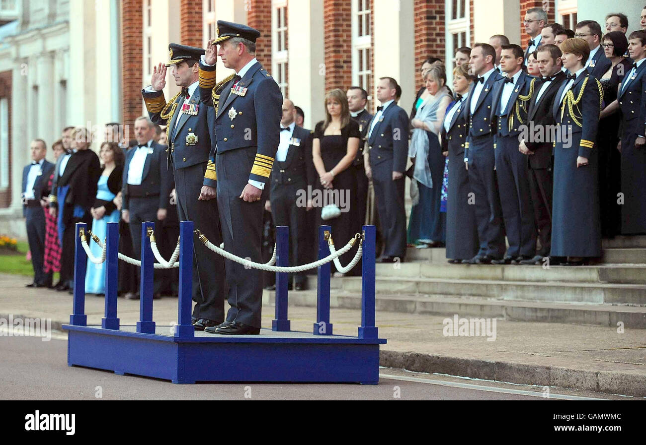 The Prince of Wales, right and Chief of the Air Staff, Air Chief Marshal Sir Glenn Torpy, left, salute during a Sunset Ceremony at RAF Cranwell in Lincolnshire as part of the RAF's 90th anniversary celebrations. Stock Photo