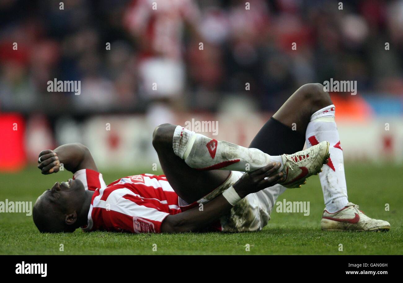 Stoke City's goal scorer Mamady Sidibe lies injured before going off on a stretcher during the Coca-Cola Championship match at the Britannia Stadium, Stoke. Stock Photo