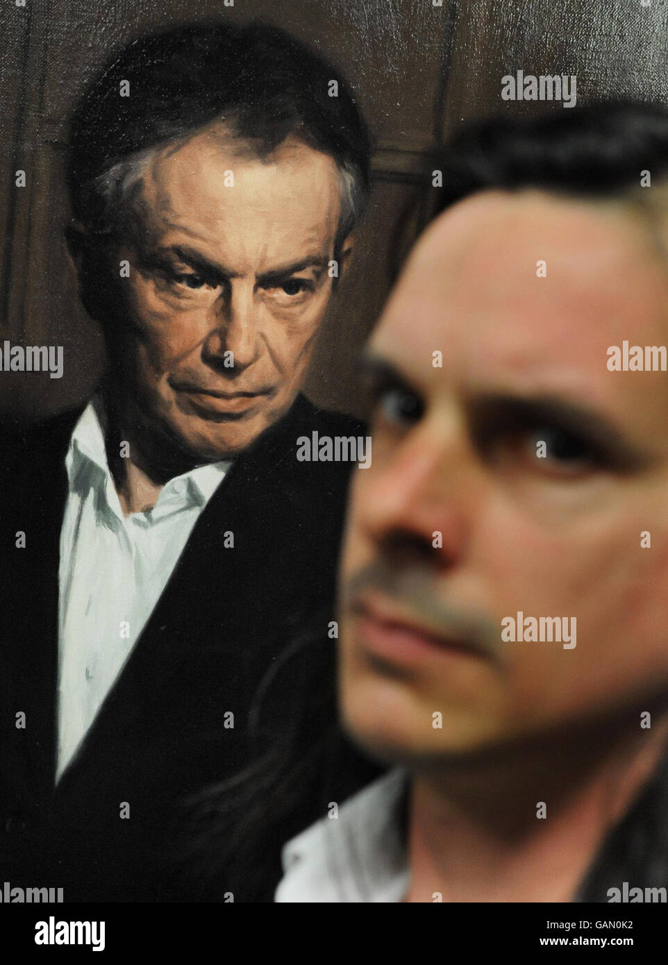 A portrait of former Prime minister Tony Blair by artist Phil Hale (Right) goes on show at Portcullis House in Westminster, central London. Stock Photo