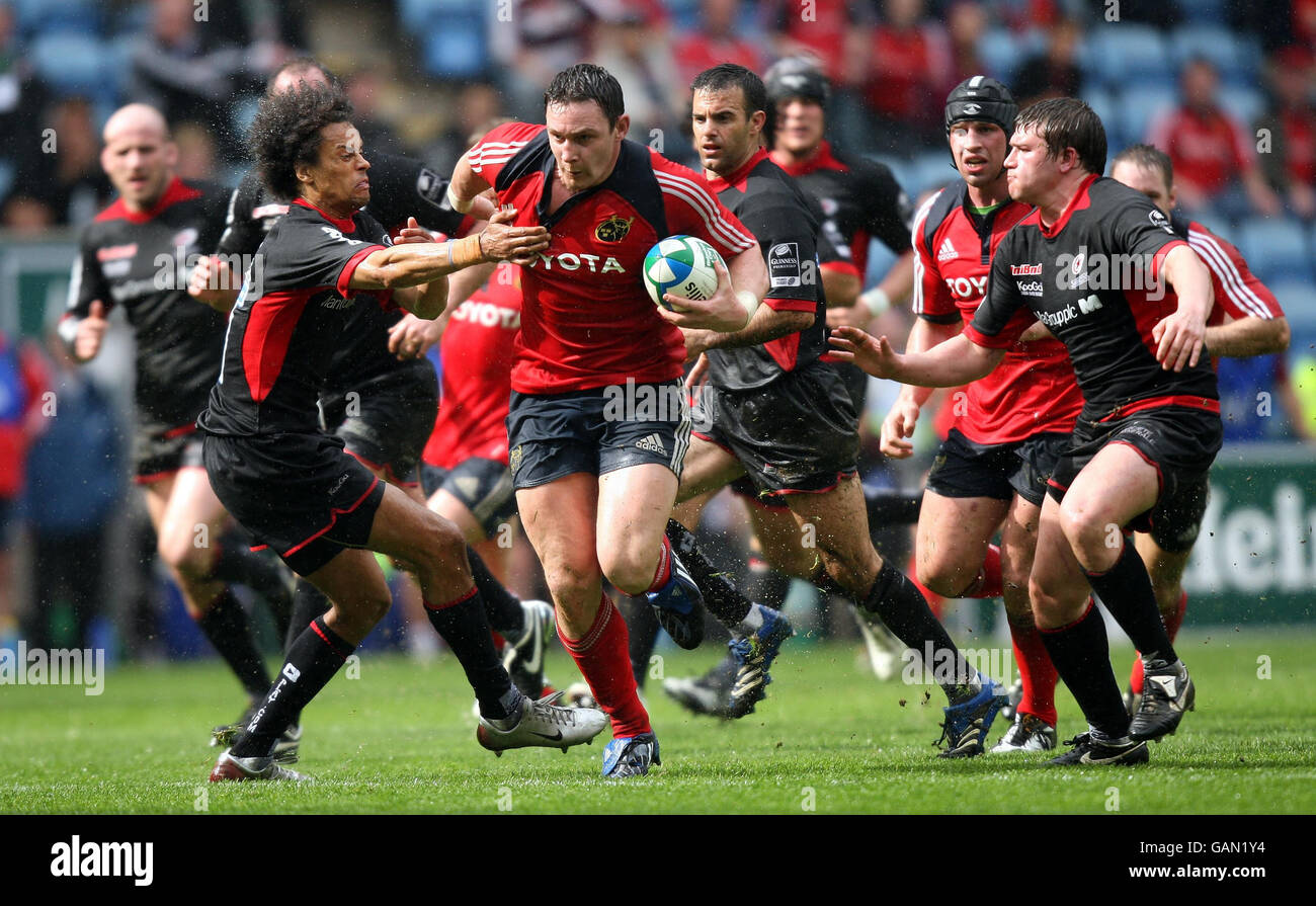Munster's David Wallace hands off Saracens Richard Haughton during the Heineken Cup Semi Final at the Ricoh Arena, Coventry. Stock Photo