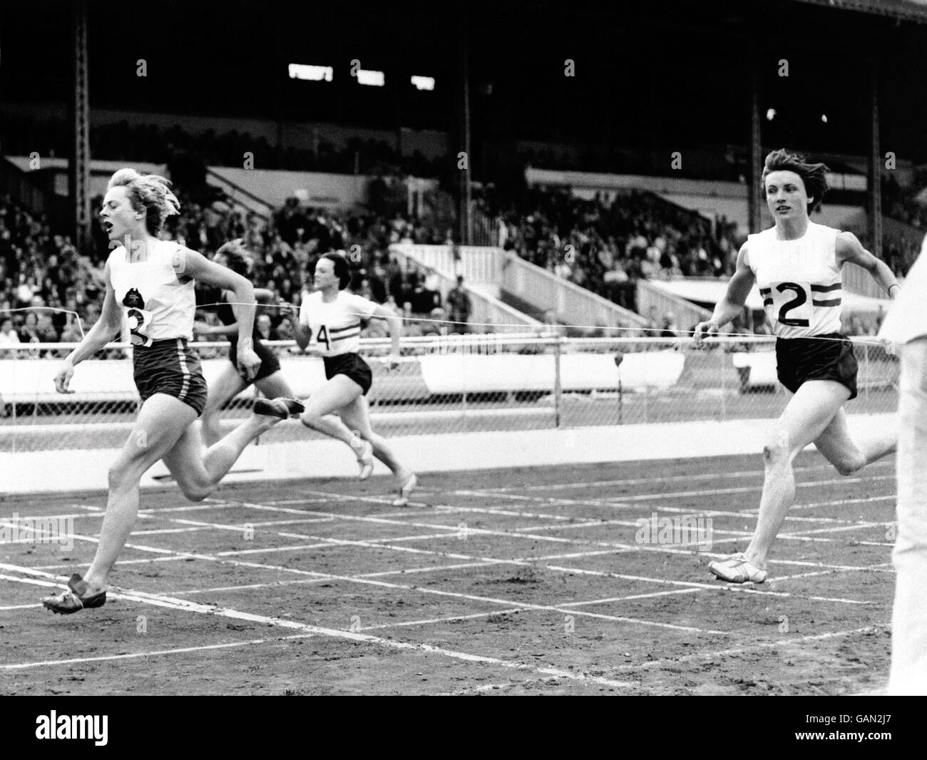 Australia's Betty Cuthbert (l) wins the women's 220yds from Great Britain's Heather Young (r) Stock Photo