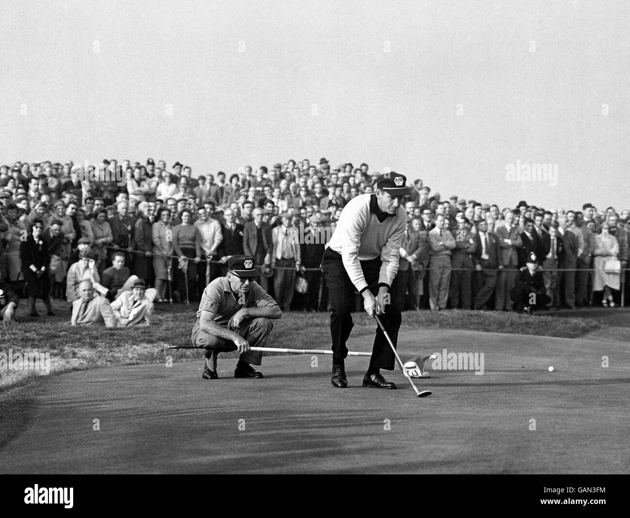 Golf - Ryder Cup - Great Britain and Ireland v USA - Royal Lytham and St Annes. Jerry Barber, left, the United States Captain, and his partner Dow Finsterwald, sizing a putt at the 13th green. Stock Photo