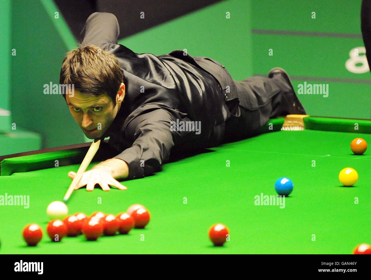 Ronnie OSullivan at the table during his semi final match in the 888 World Snooker Championship at the Crucible Theatre, Sheffield Stock Photo