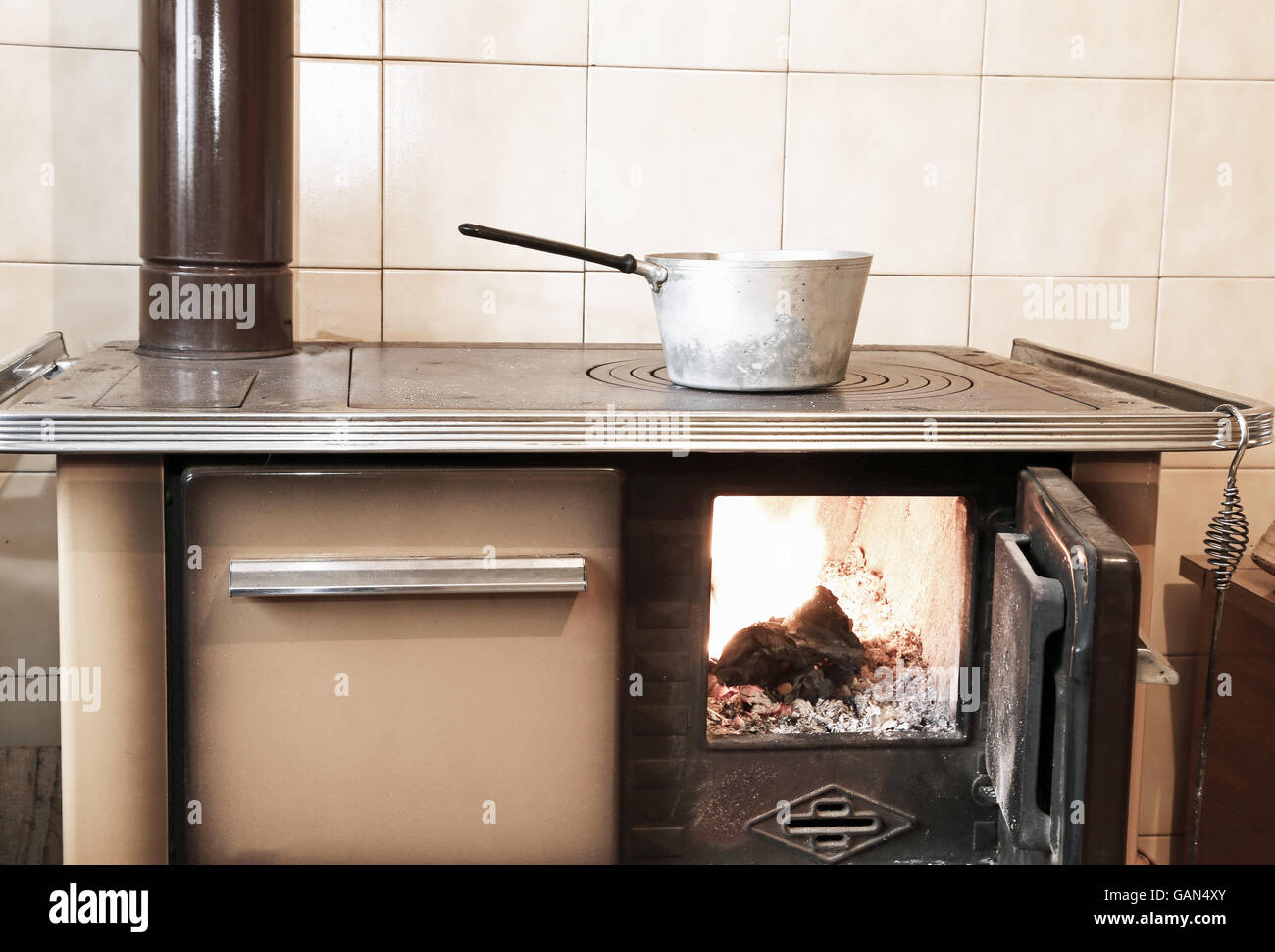 ancient woodburning stove in the kitchen of mountain home Stock Photo Alamy