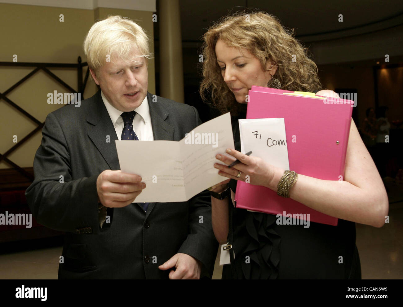Boris Johnson, Mayor of London, gets briefed by Riza Turner to present the Community Award to Capital Radio during the Sony Radio Academy Awards at the Grosvenor House Hotel in central London. Stock Photo