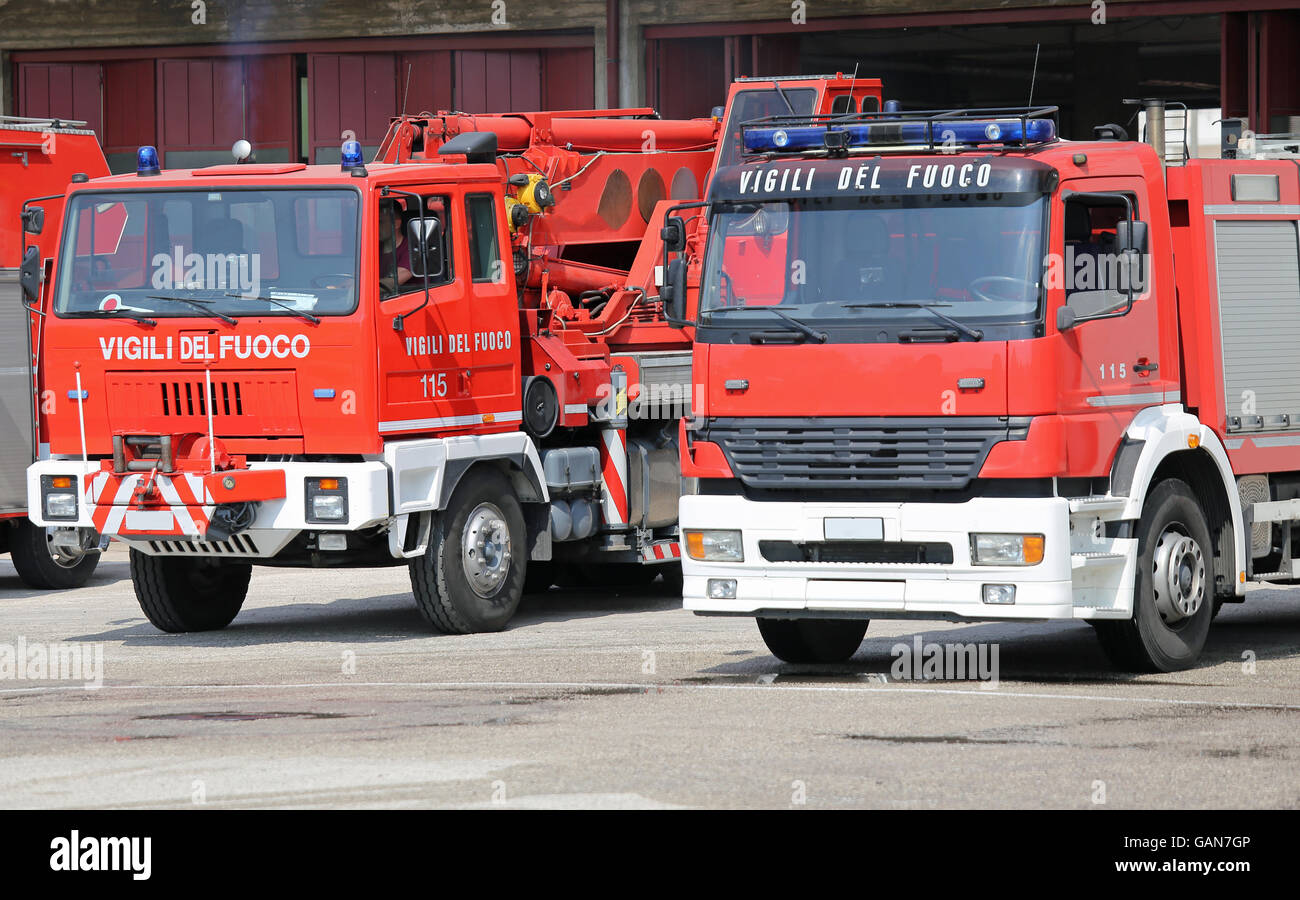 red truck fire engines firefighters during a fire drill training in the barracks of the fire brigade Stock Photo