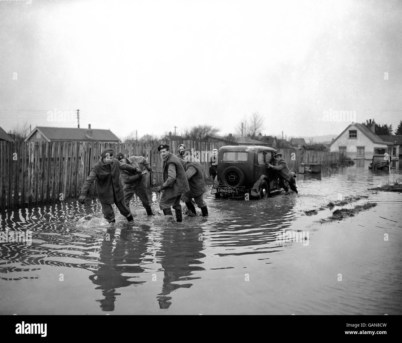 Servicemen hauling a car through the flood water at Canvey Island, Essex. Stock Photo