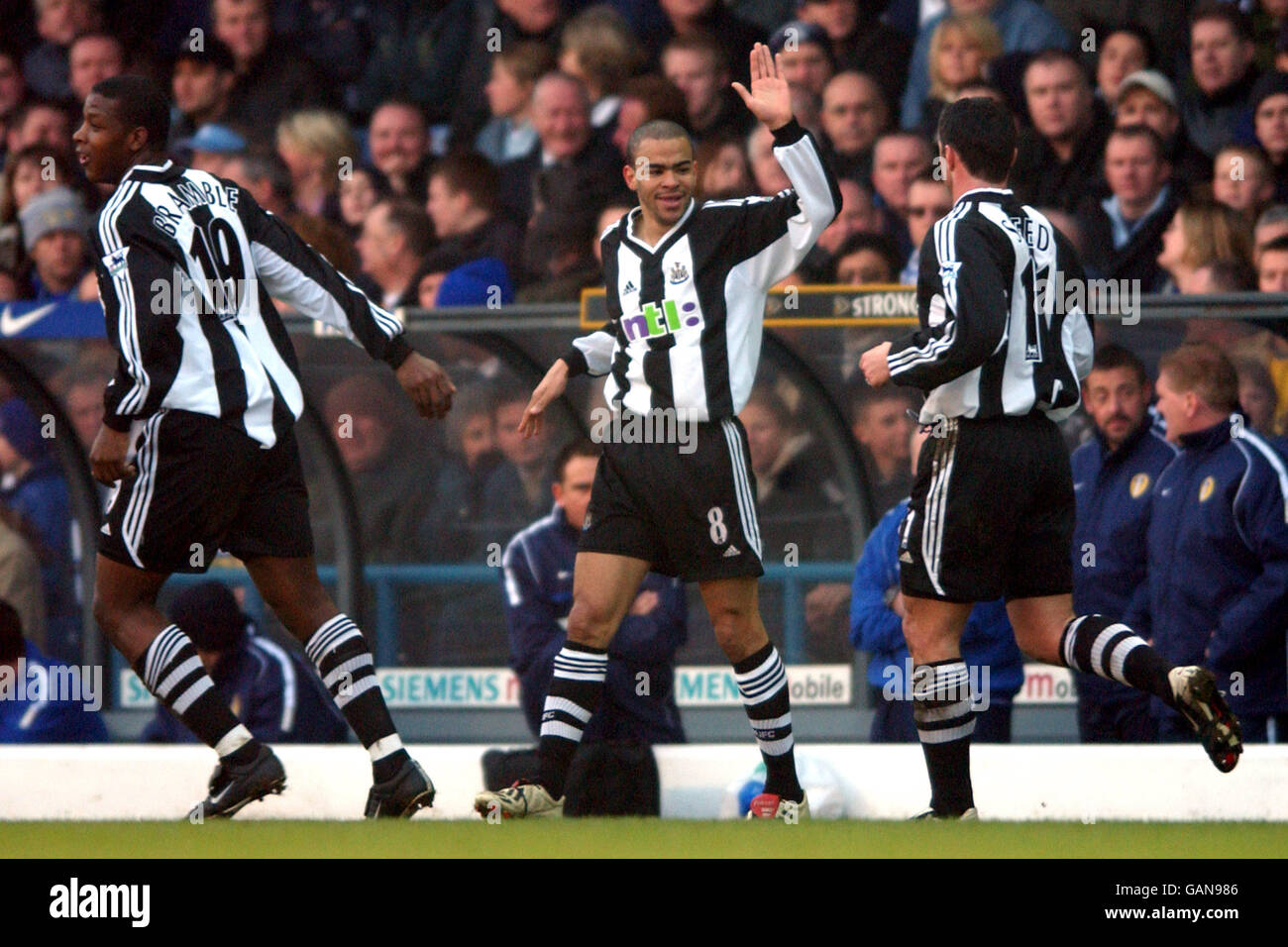 Newcastle United's Kieron Dyer celebrates with Gary Speed (r) and Titus Bramble (l) his team mates after scoring the opening goal against Leeds United Stock Photo