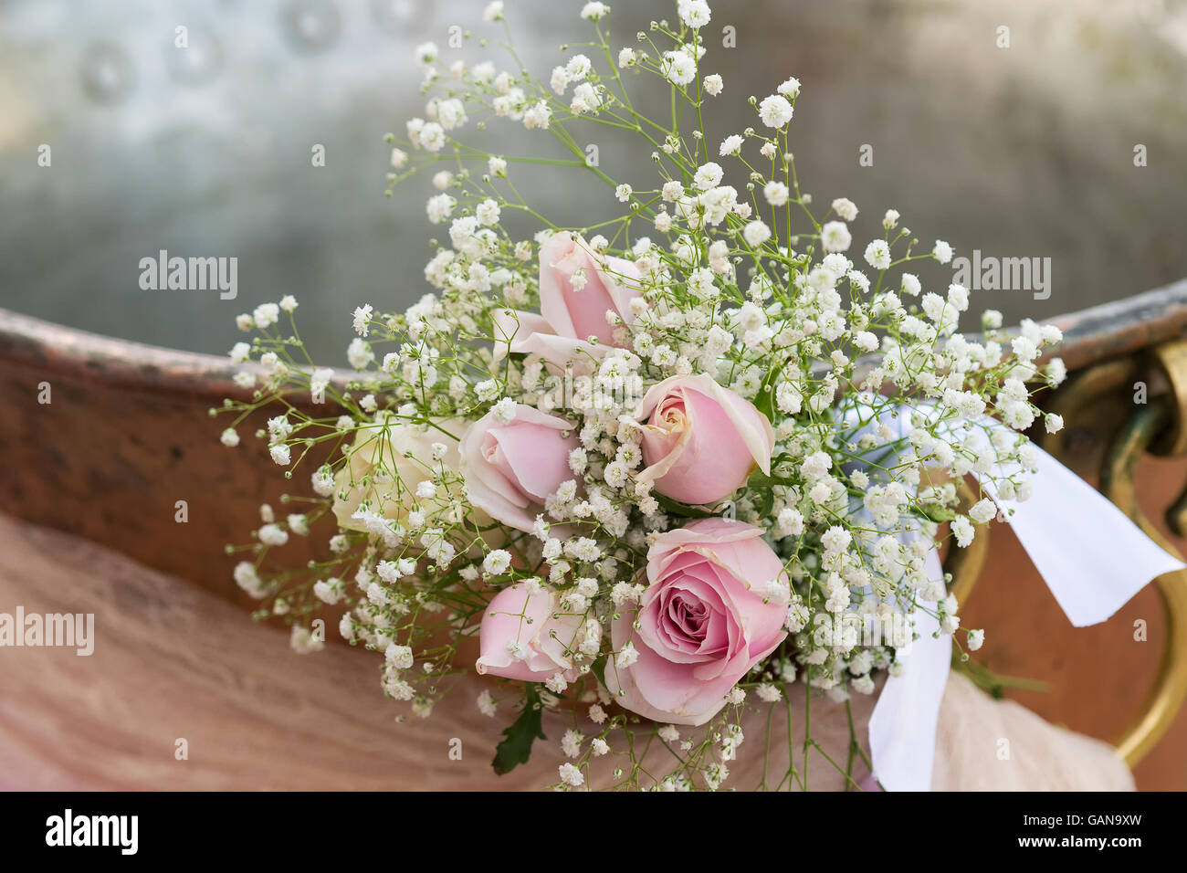 Christian baptismal with a bouquet of flowers at the front. Stock Photo