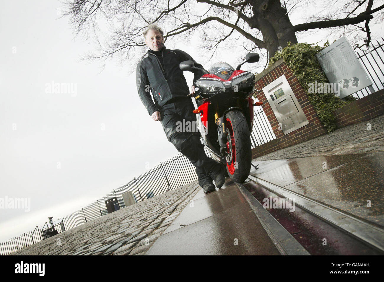 World record breaker Nick Sanders prepares to set off from the Meridian Time Line in Greenwich, London as he embarks on the toughest motorcycle journey known to man. Stock Photo