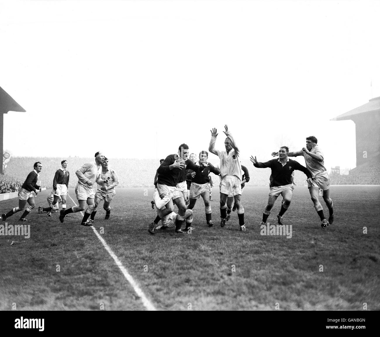 Wales' Brian Thomas (c) is tackled from behind as England's Stanley Hodgson (third r) tries scare tactics Stock Photo