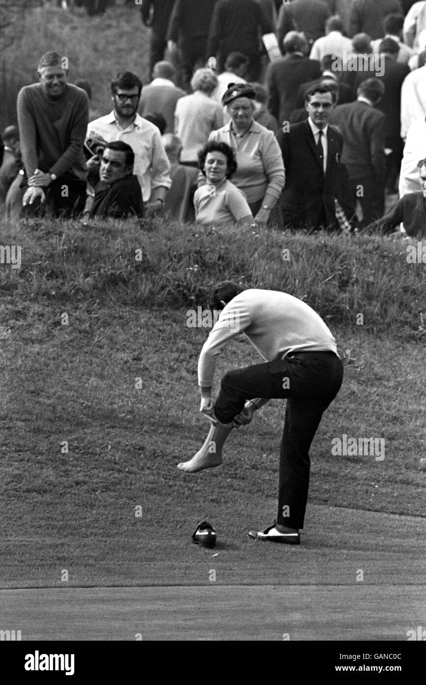 Golf - Ryder Cup - Great Britain and Ireland v USA - Royal Birkdale. Britain's Tony Jacklin takes time out to put a plaster on his foot during one of the opening day's play. Stock Photo