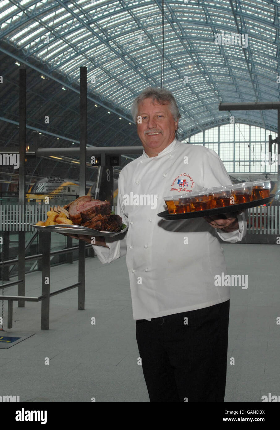 Celebrity chef Brian Turner at St. Pancras International Station, London, welcoming commuters from France with roast beef as part of St George's Day celebrations. Stock Photo