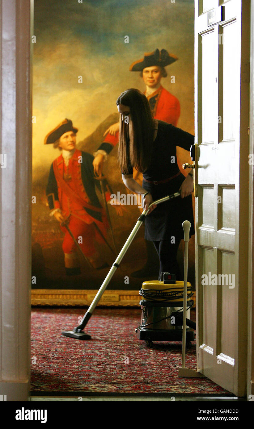 An employee of Christie's cleans the carpet in the Merrion Hotel ahead of a public viewing of Irish Art before Christie's Annual Sale, due to take place in London next month. Stock Photo