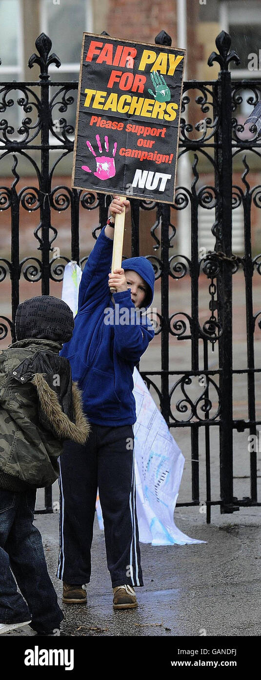 Young supporters holding placards support the National Union of Teachers strike, outside a school in Leeds. Stock Photo