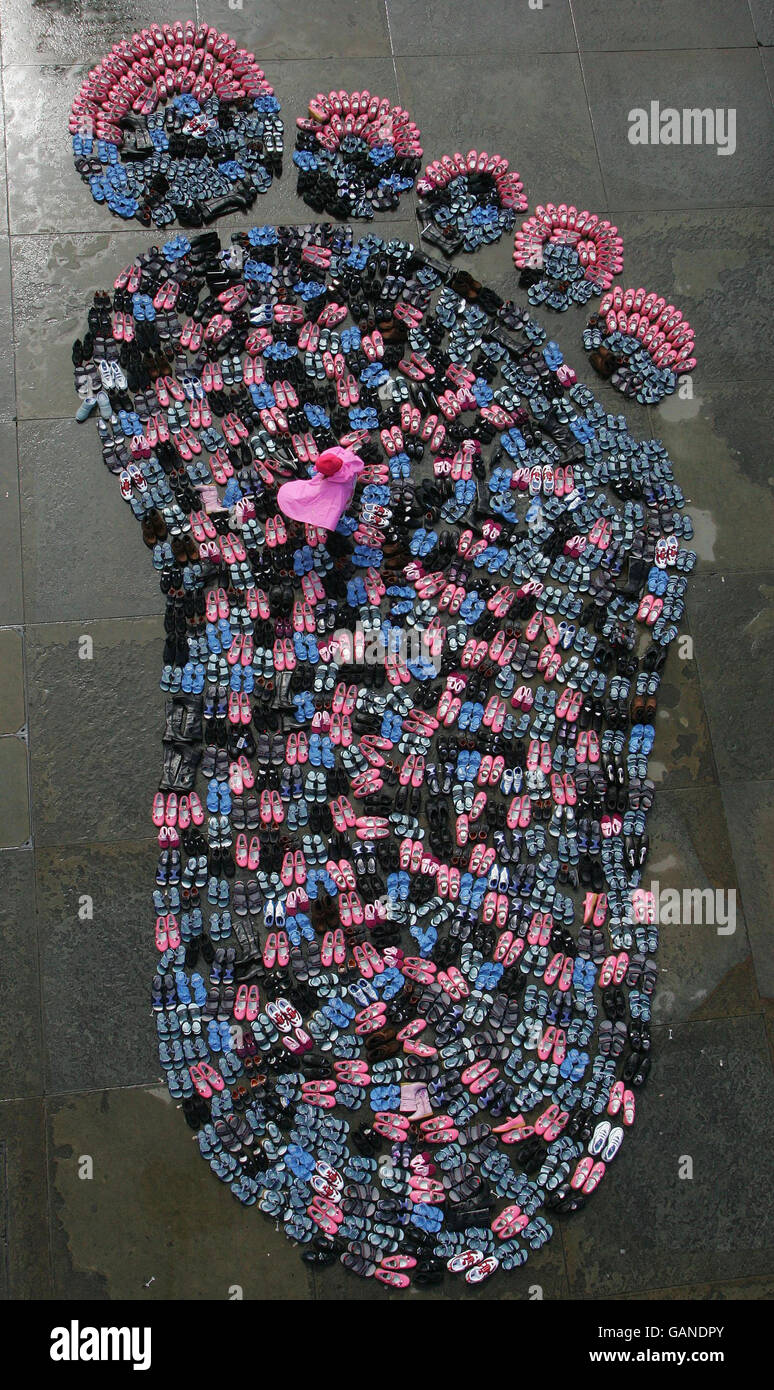 A young girl walks through thousands of shoes, each representing a ...