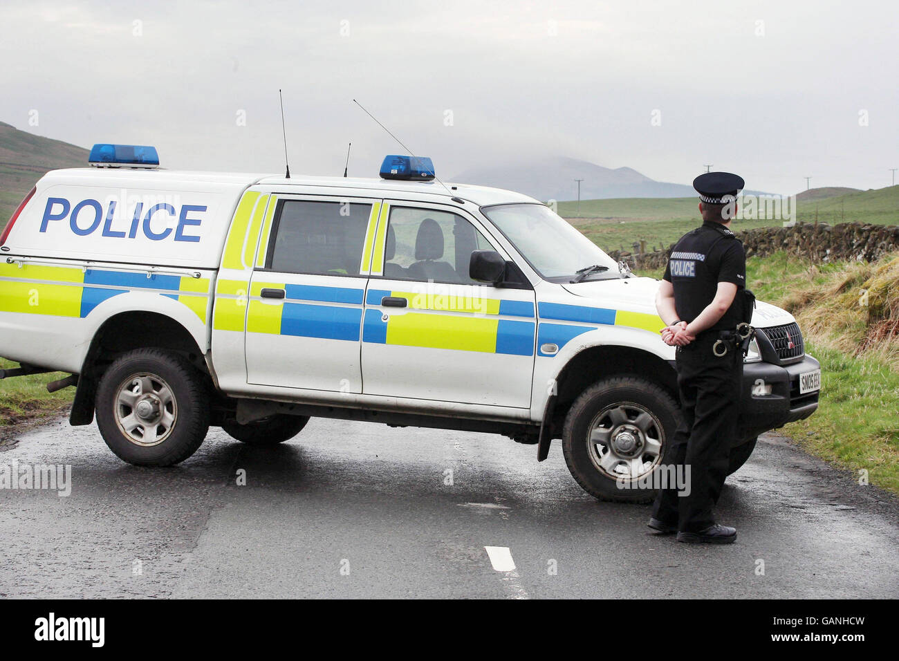 A police car blocks the road near Lennoxtown after two boys age two and six  were found dead in a car in a car park near Campsie golf course Stock Photo  -