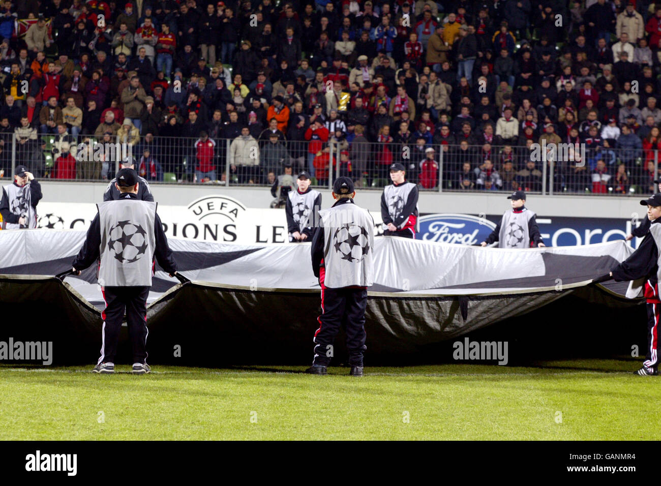 Ballboys surround the giant UEFA Champions League starball logo in the centre circle Stock Photo