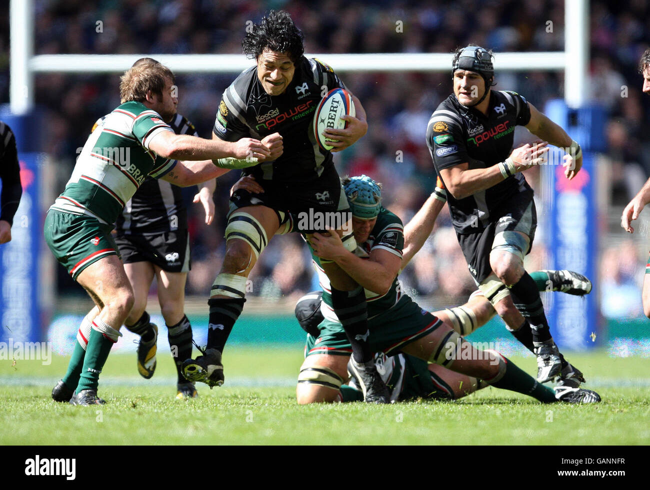 Ospreys' Filo Tiatia charges at Leicester Tigers Martin Castrogiovanni and Jordan Crane during EDF Energy Cup Final match at Twickenham, London. Stock Photo
