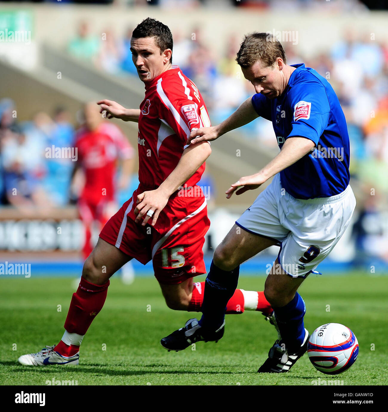 Millwall's Neill Harris and Carlisle United's Paul Arnison battle for the ball during the Coca-Cola Football League One match at The Den, Millwall. Stock Photo
