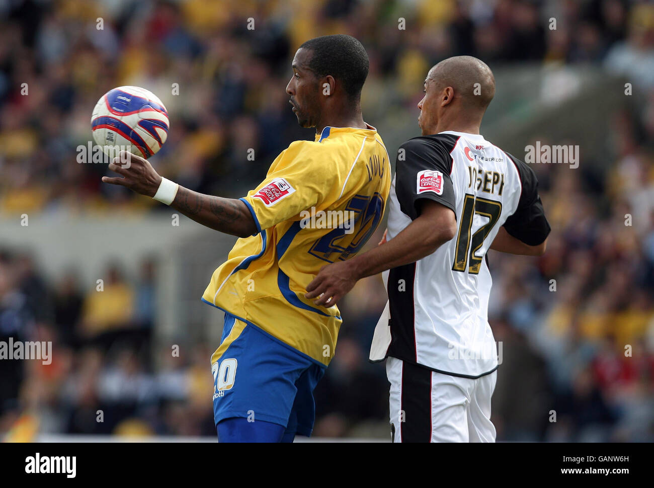 Mansfield Town's Jefferson Louis and Rotherham United's Marc Joseph (right) battles for the ball during the Coca-Cola Football League Two match at Field Mill, Mansfield. Stock Photo