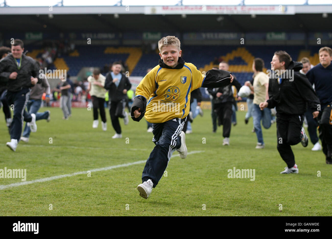 Mansfield Town's fans invade the pitch after the Coca-Cola Football League Two match at Field Mill, Mansfield. Stock Photo