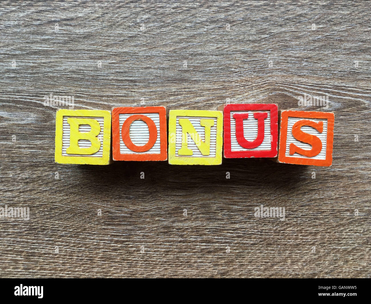 Bonus word made with toy wood blocks letters Stock Photo - Alamy