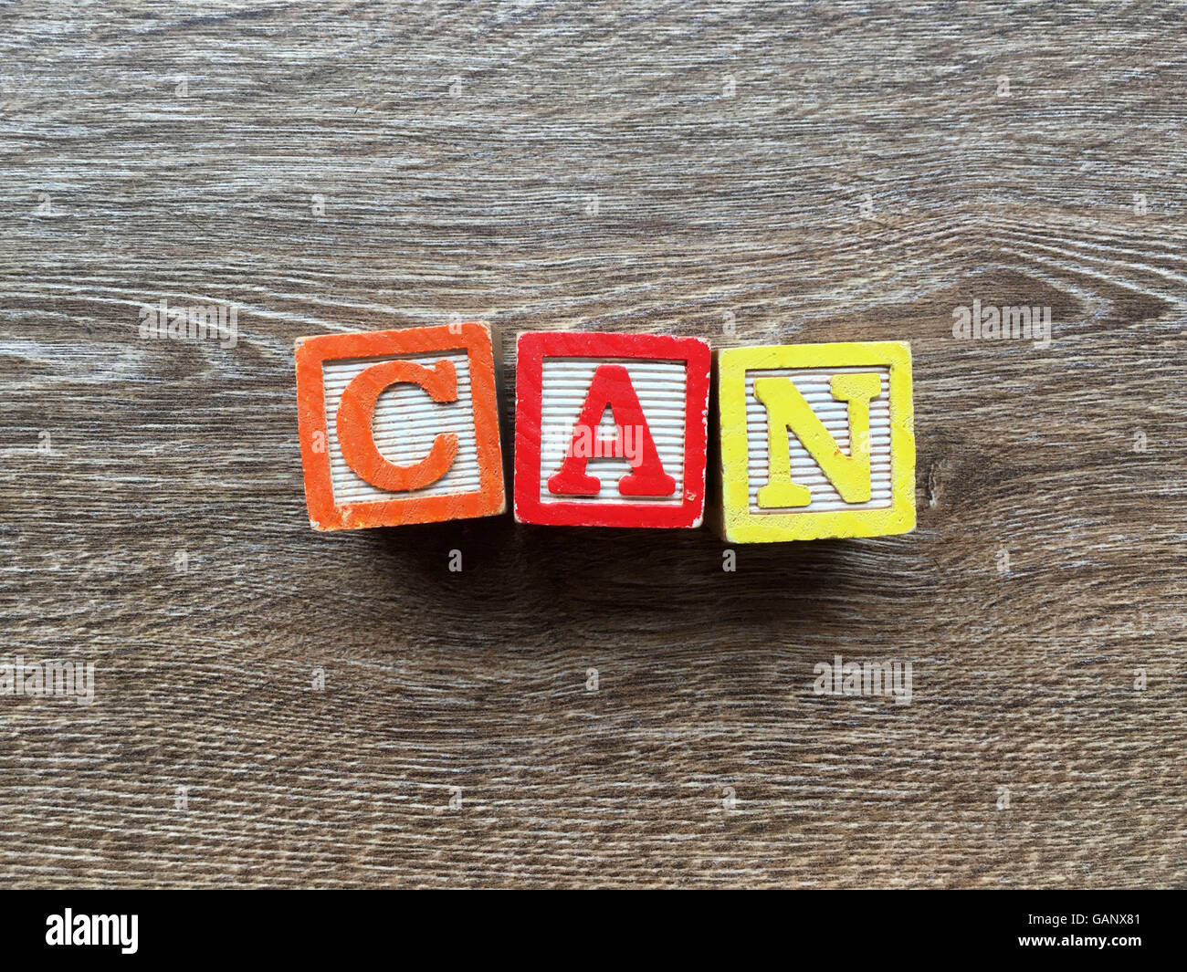 CAN word made with toy wood blocks letters Stock Photo