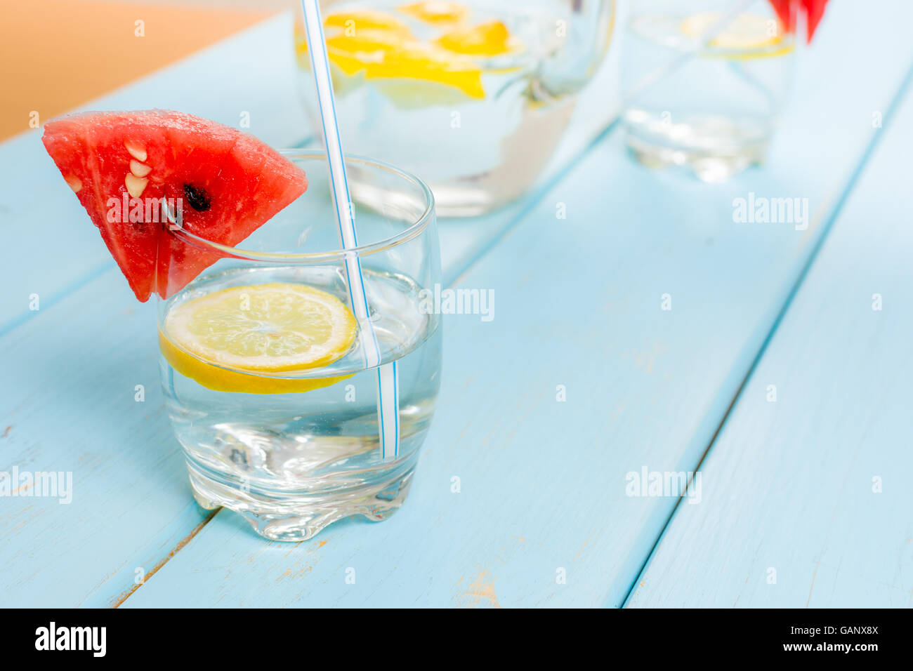 Fresh water with lemon and melon on blue wood table Stock Photo