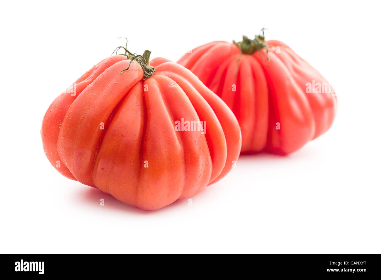 Coeur De Boeuf. Beefsteak tomatoes isolated on white background. Stock Photo