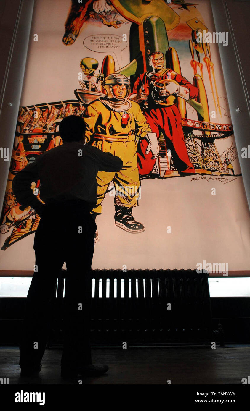 A visitor looks at a Dan Dare print at the new Dan Dare and the Birth of Hi-tech Britain exhibition, which opened today at the Science Museum in London. Stock Photo