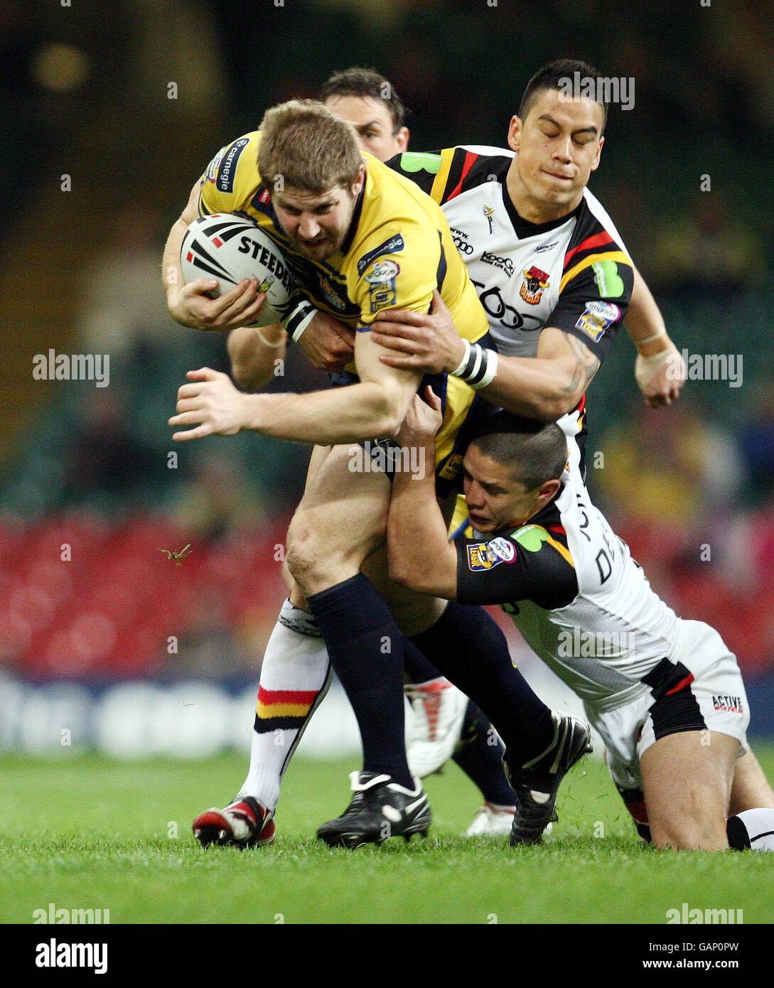 Bradford Bulls Shontayne Hape and Paul Deacon tackle Leeds Rhinos Nick Scrutton during the engage Super League match at the Millennium Stadium, Cardiff. Stock Photo
