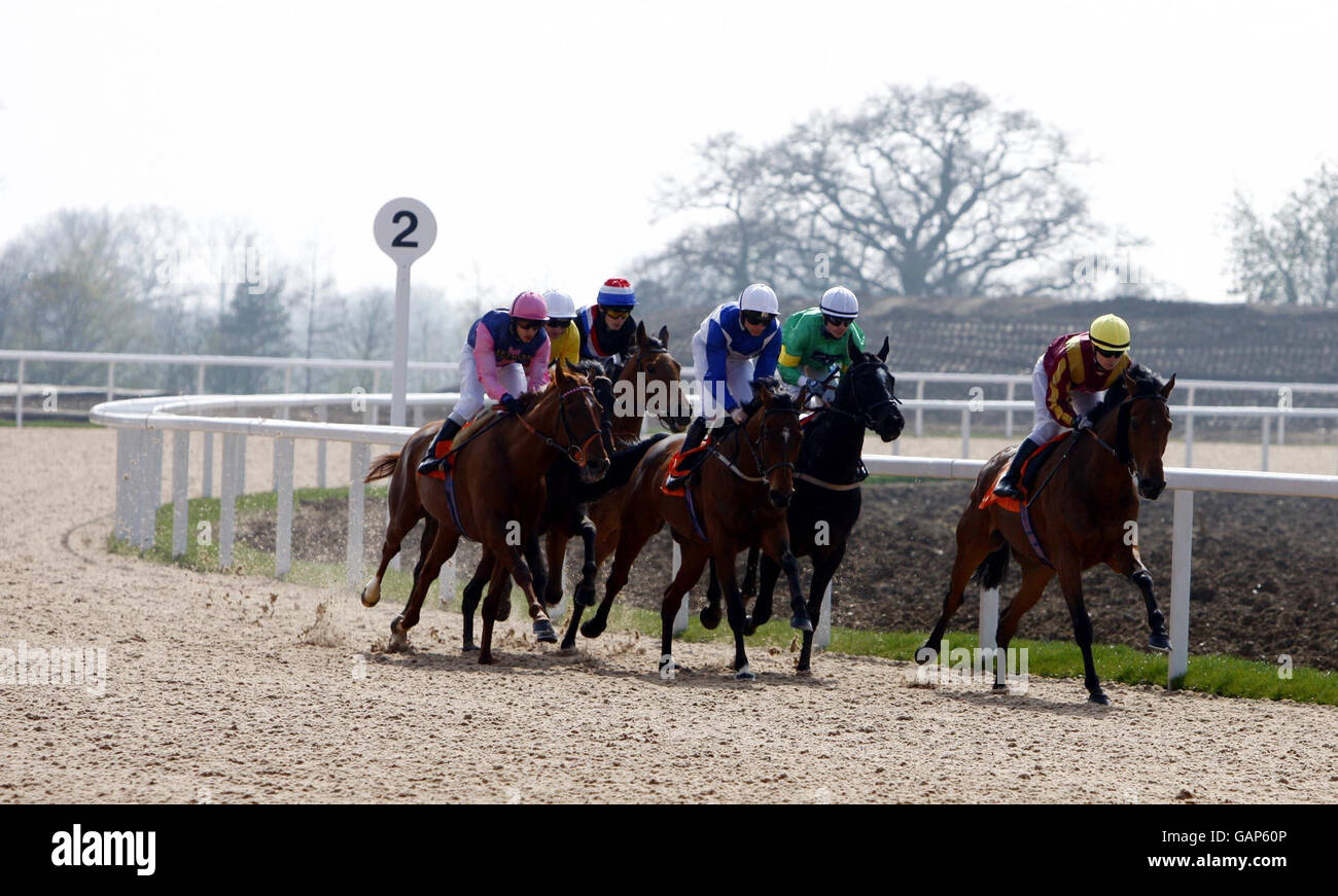 Eventual winner Pocket Too and jockey Kirsty Milczarek leads round the bend during the greatleighs.com Handicap Stakes at Great Leighs Racecourse in Chelmsford, Essex. Stock Photo