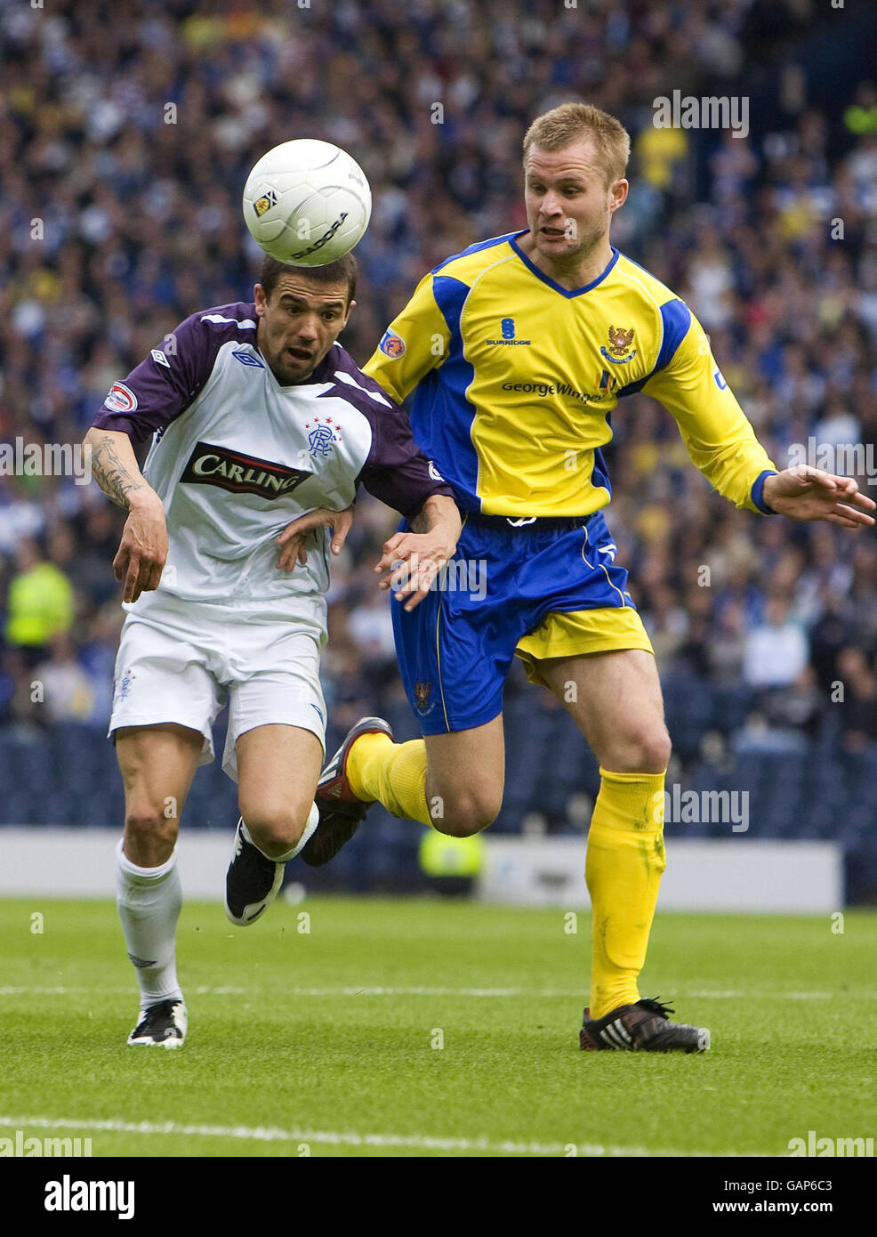 Rangers' Nacho Novo battles with St Johnstone's Kevin Rutkiewicz during ...