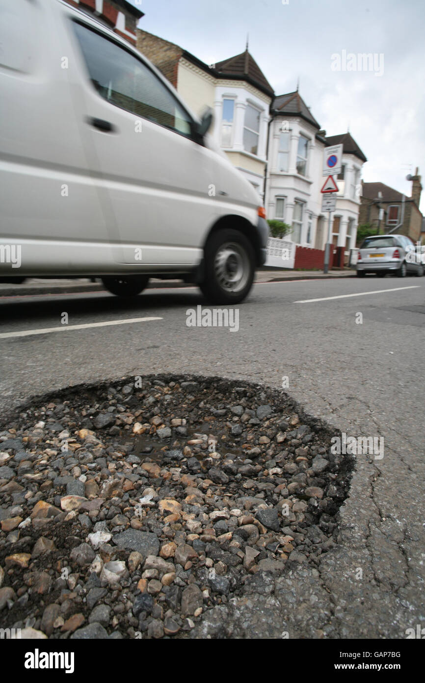 A pothole in a road in Tooting, SW London. Stock Photo