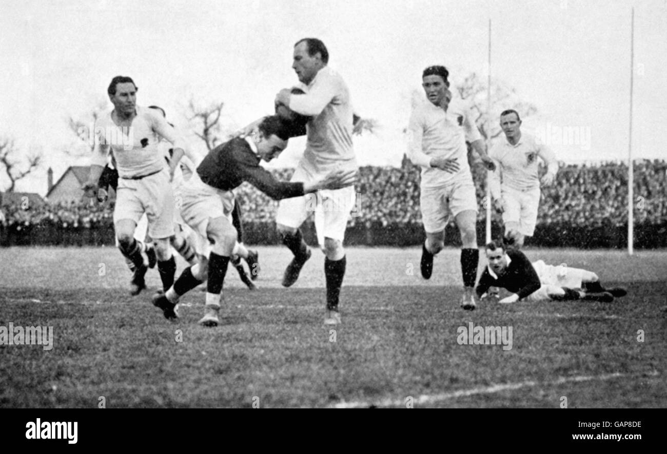 England's FE Oakeley (c) tries to break down the wing, with support from teammates Alfred Maynard (l), Sidney Smart (second r) and Ronald Poulton-Palmer (r). Stock Photo