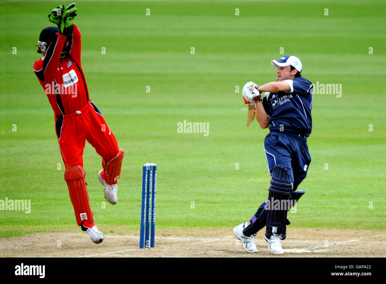 Cricket - Friends Provident Trophy - Lancashire v Scottish Saltires - Old Trafford. Scotland's Ed Cowan hits one over the top despite the attempts of Lancashire wicketkeeper Luke Sutton Stock Photo