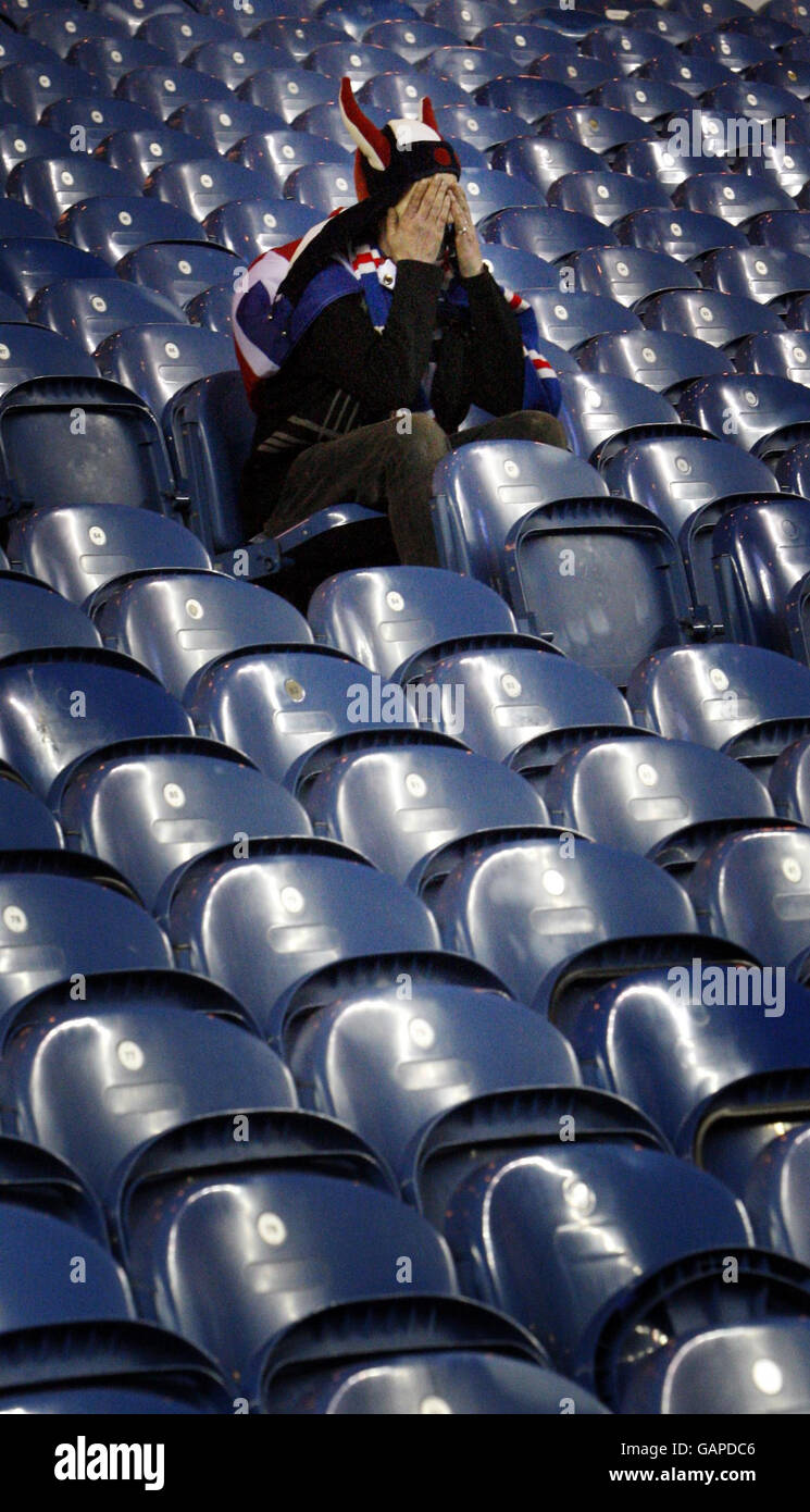 A Rangers fan looks dejected after watching the UEFA Cup Final between Rangers and Zenit St Petersburg on big screen at Ibrox Stadium, Glasgow. Stock Photo